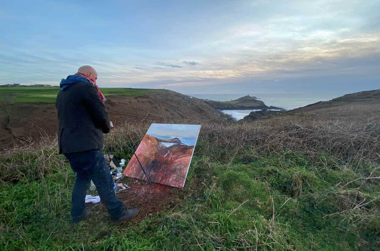 Artist Kurt Jackson painting on the cliffs