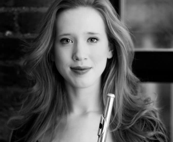 Black and white photo of Jenny Dyson holding a flute