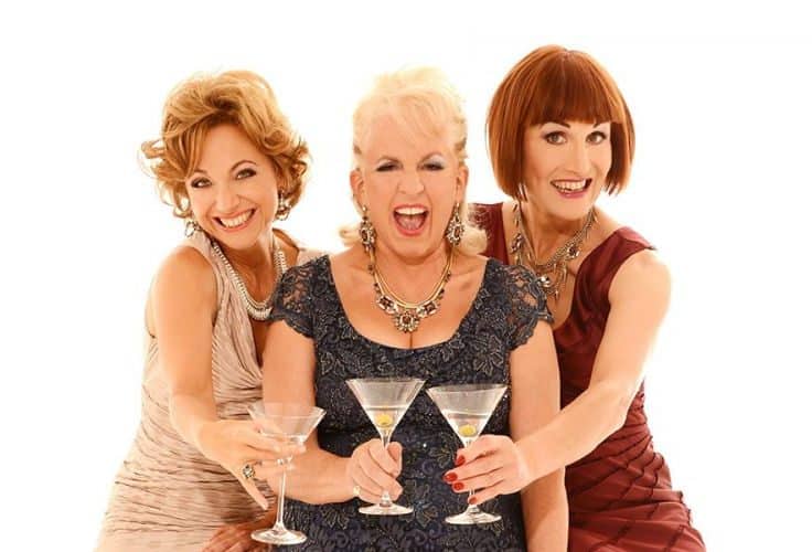 Fascinating Aida group smiling and holding martinis