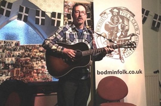 Guitarist performing during an open house event at bodmin folk club