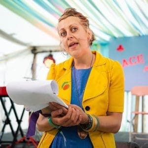 A woman speaking in an event for emerging writers