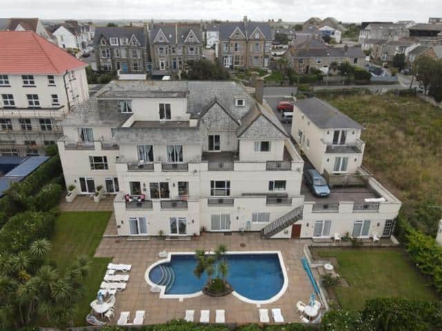 Aerial view of coastal house with swimming pool.