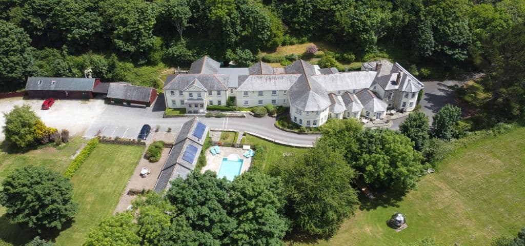Aerial view of countryside estate with pool.