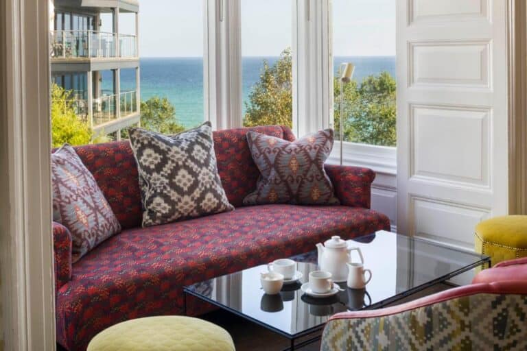 Cozy seaside living room interior with vibrant upholstery.