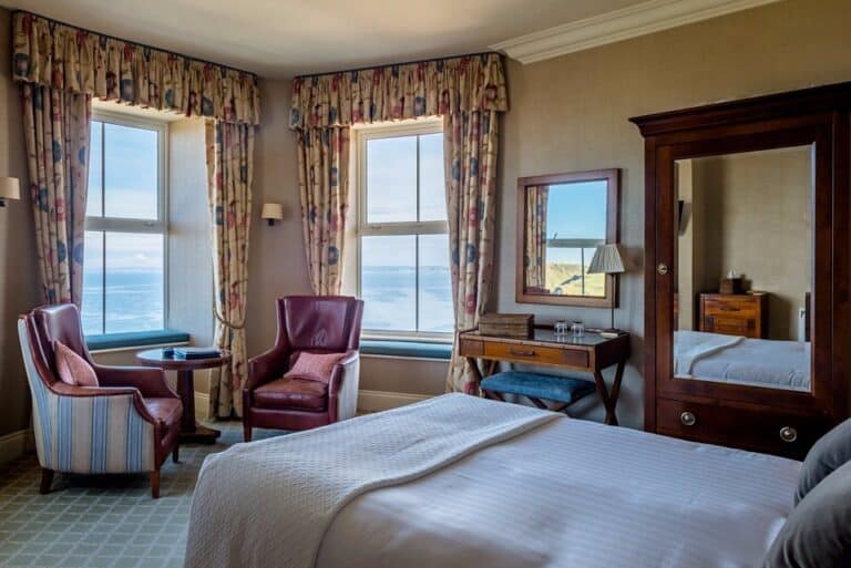 Coastal hotel room with sea view and vintage decor.