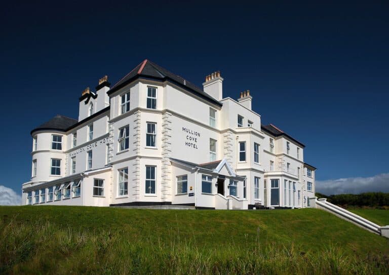 White coastal hotel under clear blue sky