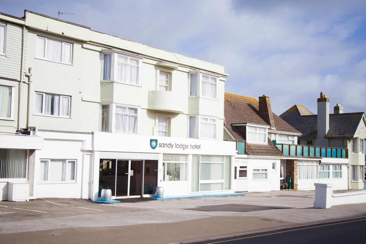 Seaside hotel facade under blue sky.