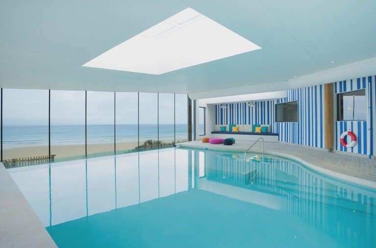 Indoor pool with ocean view, modern design.