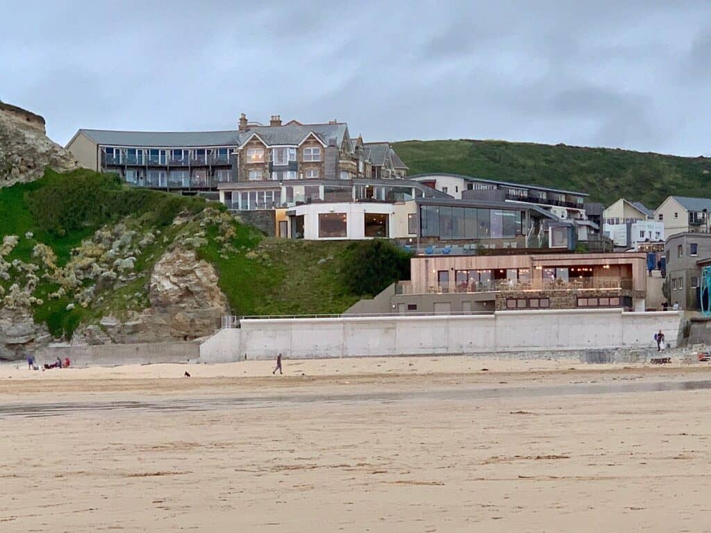 Coastal town with beach and seaside houses at dusk.